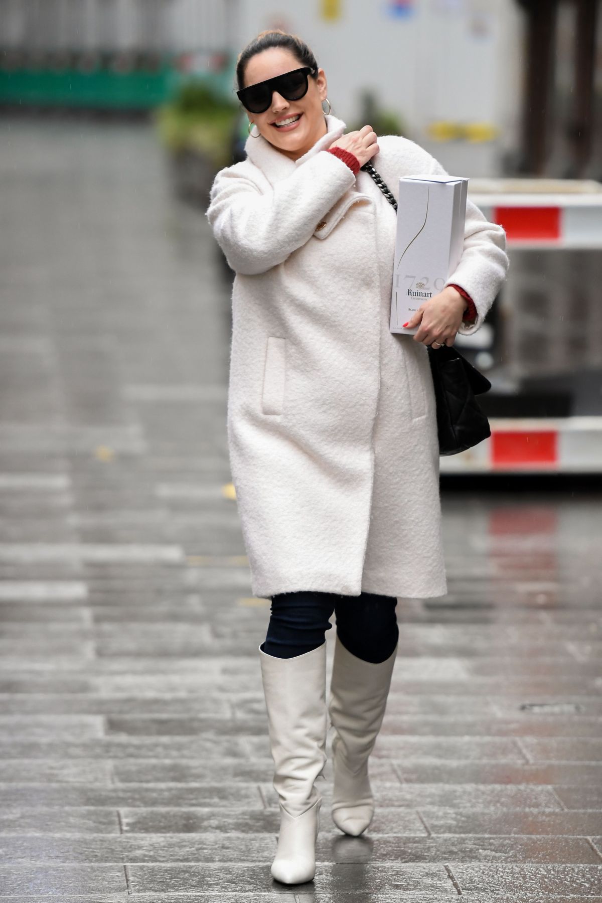 179310289_kelly-brook-in-a-white-coat-and-boots-at-global-radio-in-london-12-23-2020-5.jpg